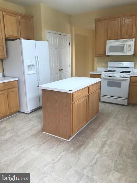 2025 Germander Way Woodbridge, VA 22192 - Photo 10 of 39 a kitchen with stainless steel appliances a stove a microwave a sink a refrigerator and cabinets
