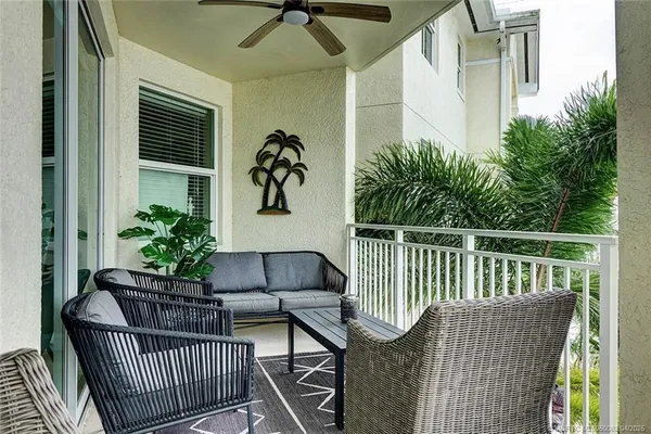 a view of balcony with furniture and potted plant