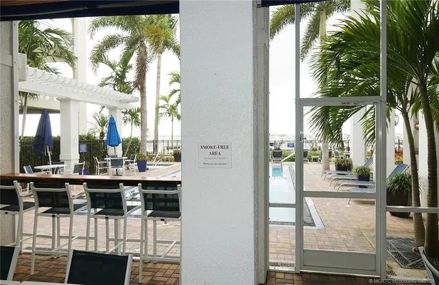a view of a dining room with a floor to ceiling window and kitchen
