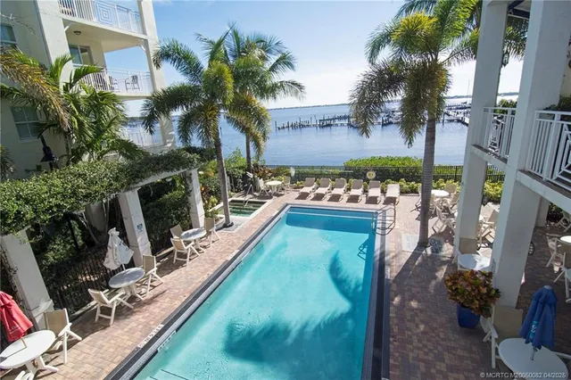 a backyard of a house with lots of green space and fountain
