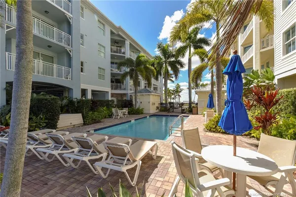 a view of a patio with couches table and chairs and potted plants