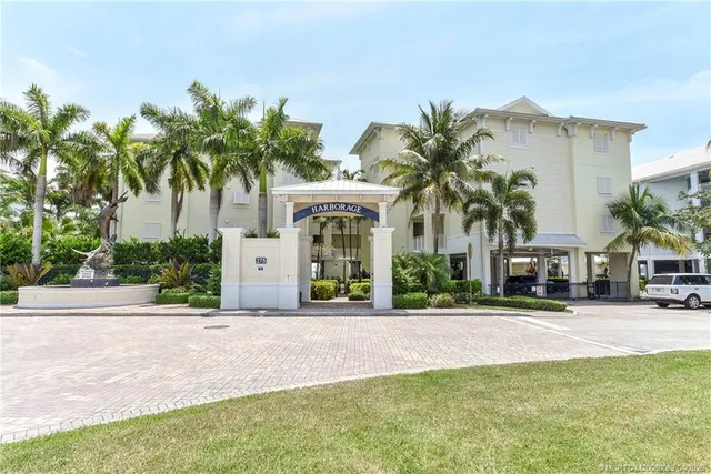 a front view of multiple house with yard and green space