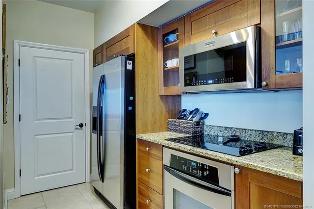 a kitchen with stainless steel appliances granite countertop a stove and a microwave