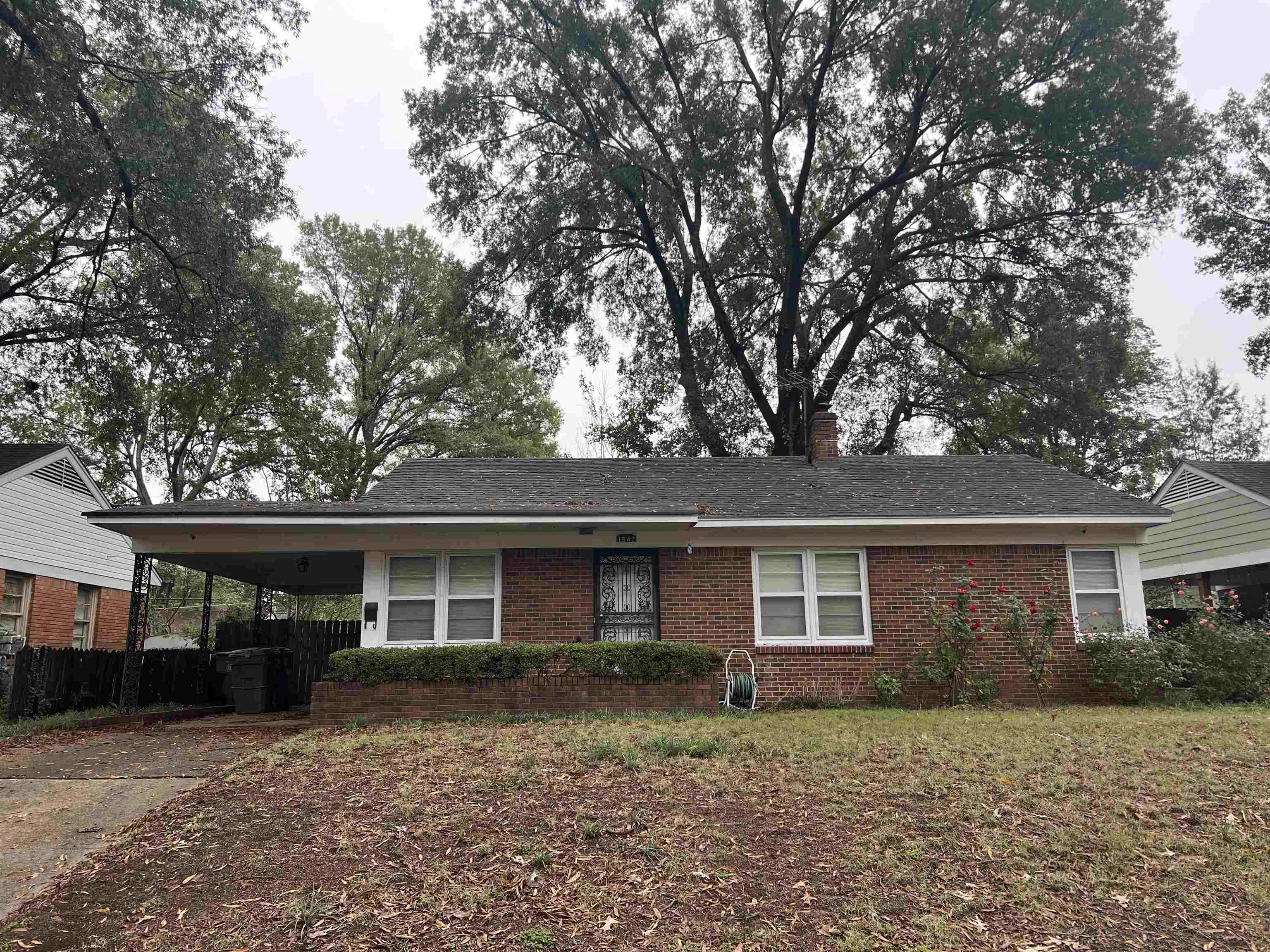 1542 Hopewell Road Memphis, TN 38117 - Photo 1 of 2 a front view of a house with a yard
