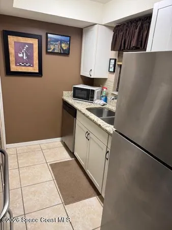a kitchen with a refrigerator and a stove