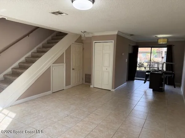 a view of a livingroom with furniture and an entryway