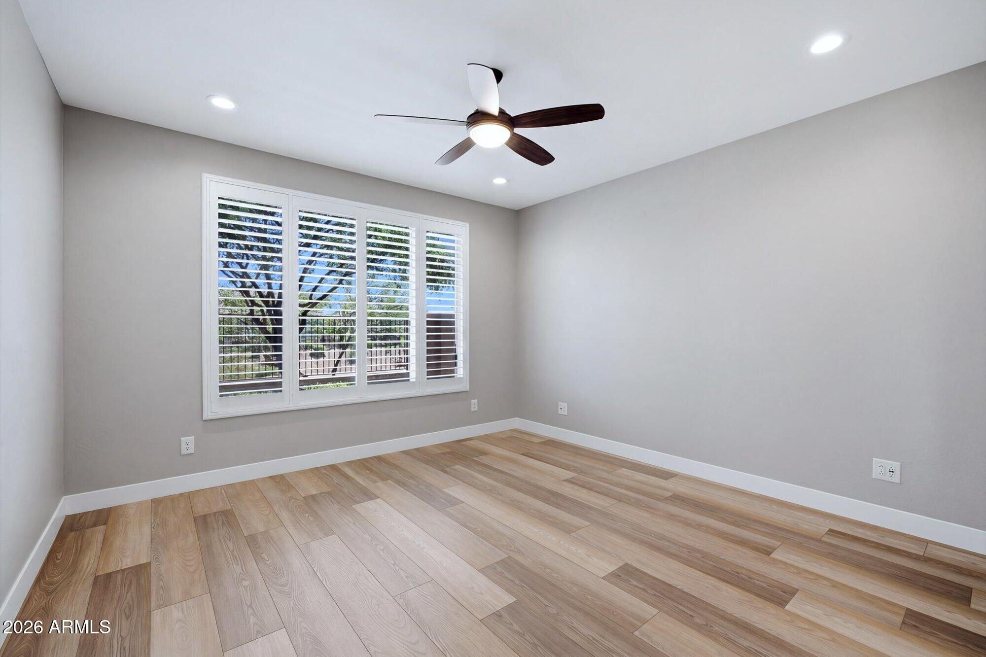 16849 West Merrell Street Goodyear, AZ 85395 - Photo 23 of 35 a view of an empty room with wooden floor and a window