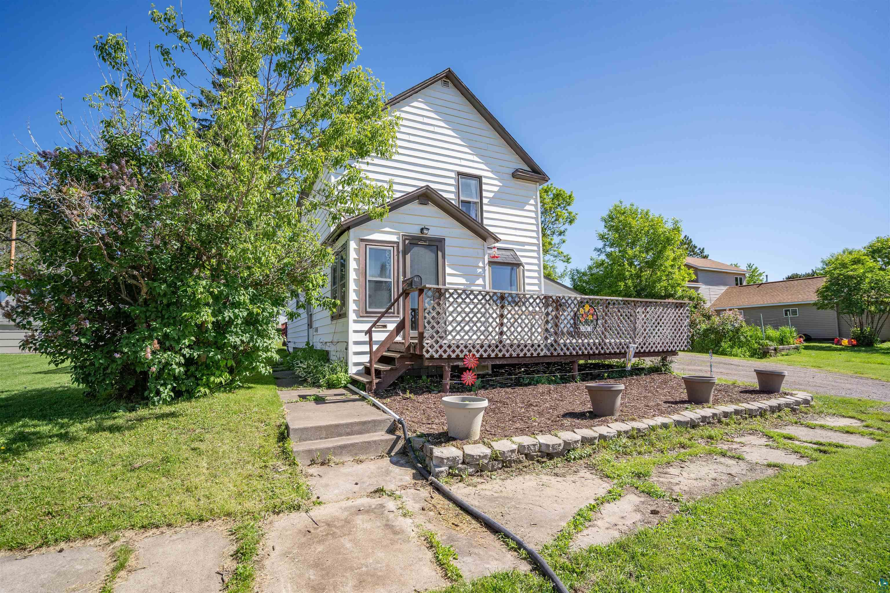 837 5th Street Proctor, MN 55810 - Photo 2 of 23 View of front facade with a wooden deck and a front yard