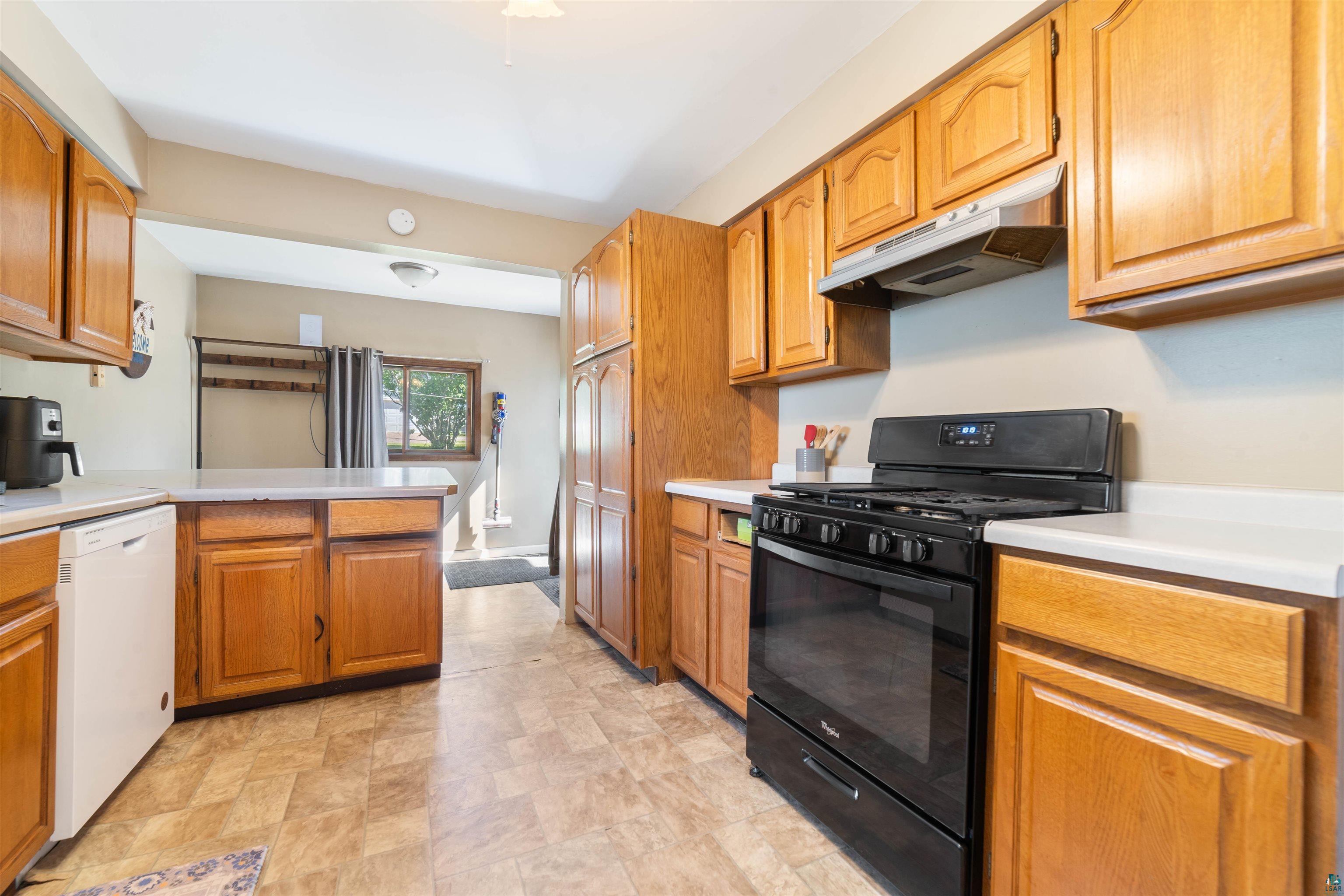 837 5th Street Proctor, MN 55810 - Photo 6 of 23 Kitchen featuring black gas range oven, dishwasher, and light tile floors