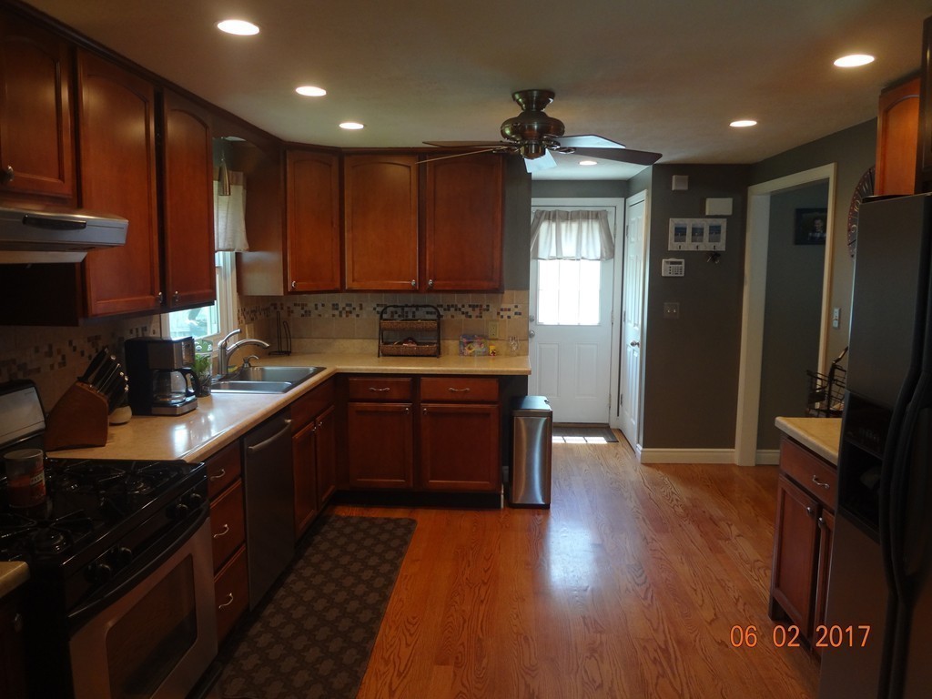 81 Calley Street Springfield, MA 01129 - Photo 8 of 26 a kitchen with stainless steel appliances granite countertop wooden cabinets a stove top oven a sink and dishwasher