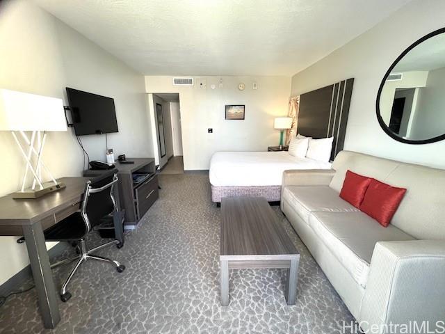 1850 Ala Moana Boulevard, Unit 915 Honolulu, HI 96815 - Photo 5 of 24 a living room with furniture a flat screen tv and kitchen view