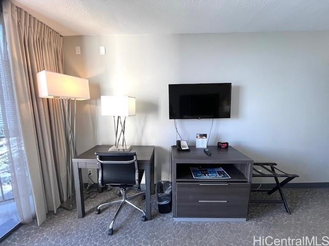 1850 Ala Moana Boulevard, Unit 915 Honolulu, HI 96815 - Photo 6 of 24 a work room with furniture and a flat screen tv