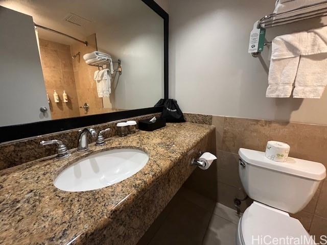 1850 Ala Moana Boulevard, Unit 915 Honolulu, HI 96815 - Photo 9 of 24 a bathroom with a granite countertop toilet a sink and a mirror