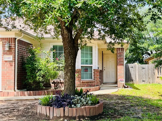 a front view of a house with a yard and fountain