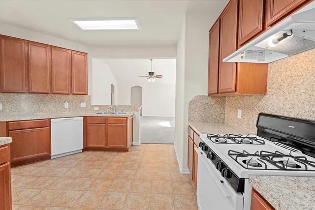 a kitchen with a stove a sink and a refrigerator