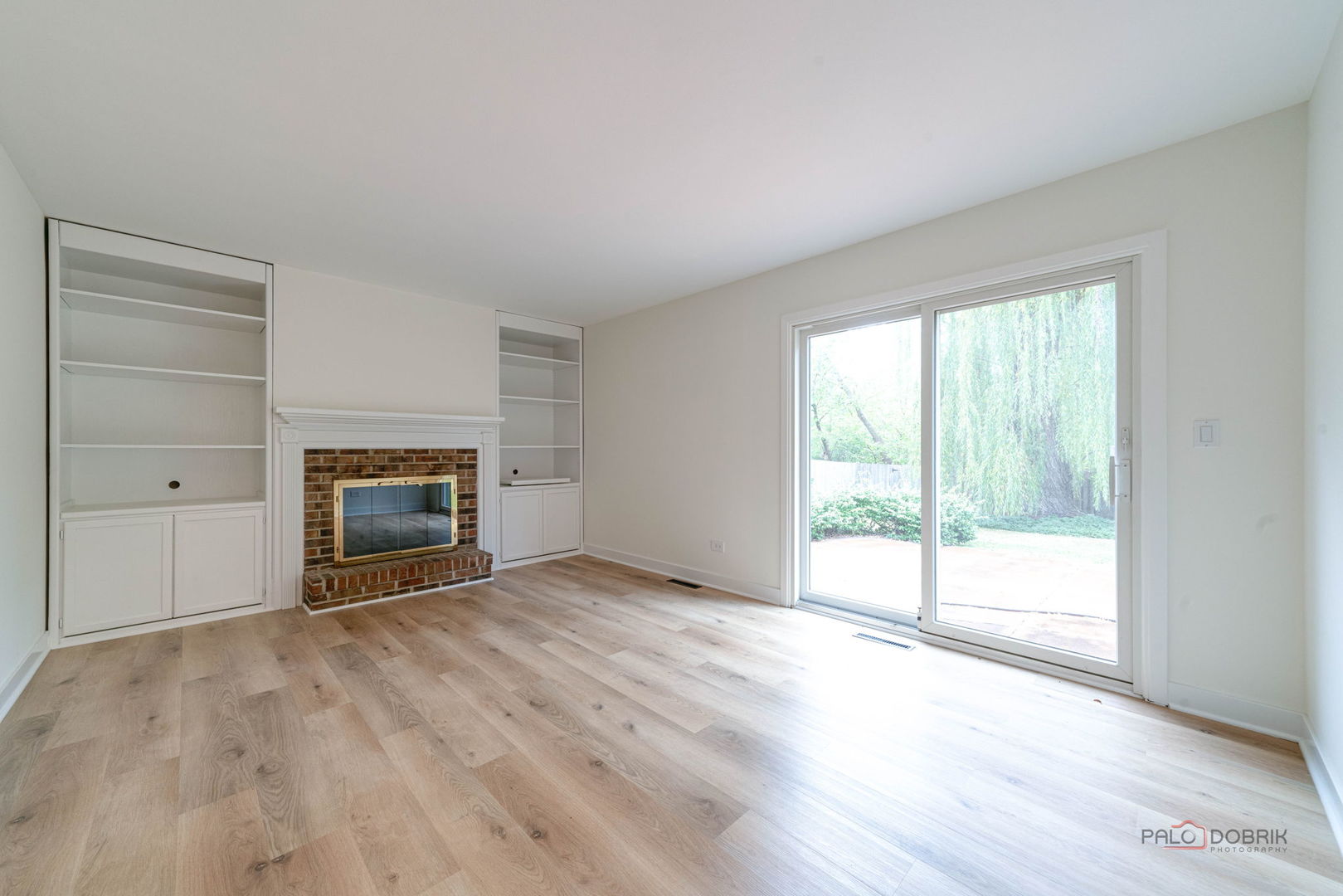 1338 Trinity Place Libertyville, IL 60048 - Photo 14 of 24 an empty room with wooden floor fireplace and windows