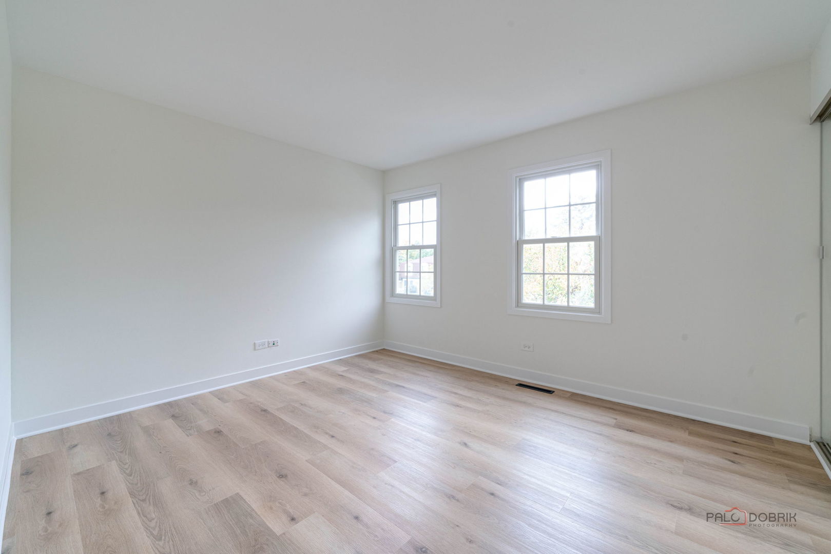 1338 Trinity Place Libertyville, IL 60048 - Photo 9 of 24 an empty room with wooden floor and windows