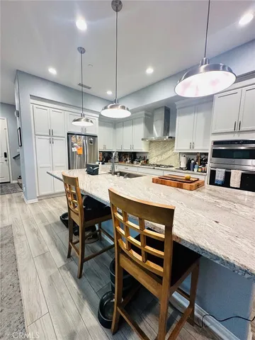 a kitchen with a table chairs and white cabinets