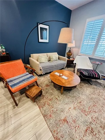 a living room with furniture and a lamp