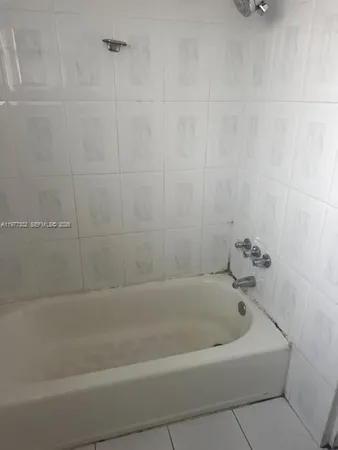 a kitchen with granite countertop a sink and cabinets