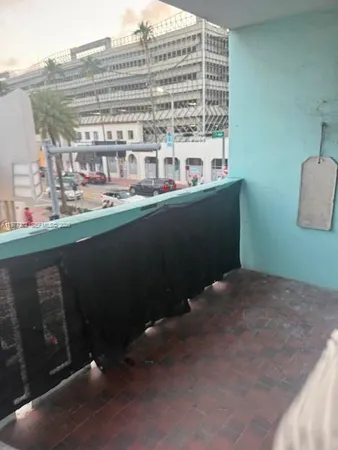 a view of a balcony with mountain view and wooden floor