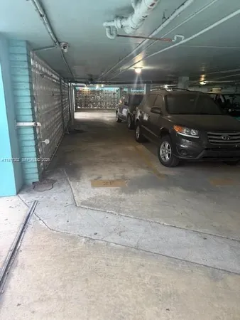 a view of parking garage with cars parked