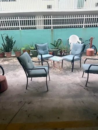 a view of a chairs and tables in the patio