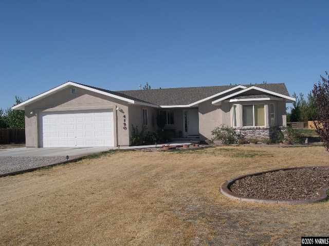 4190 Alcorn Road Fallon, NV 89406 - Photo 1 of 4 a front view of a house with a yard and garage