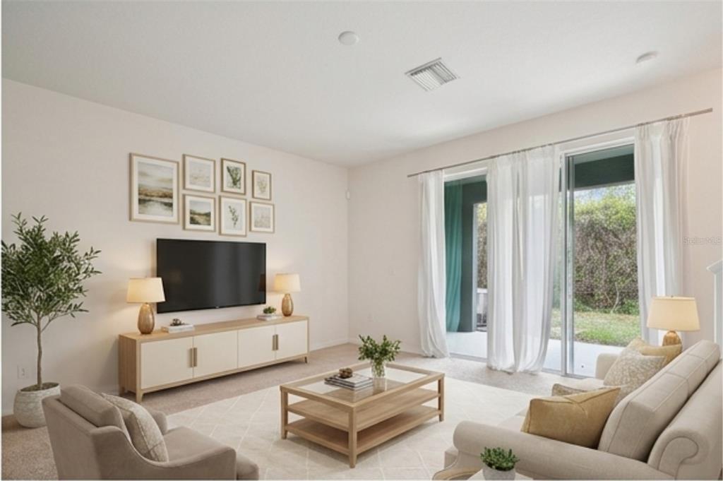 8986 Indigo Trail Loop Riverview, FL 33578 - Photo 11 of 48 a living room with furniture and a flat screen tv