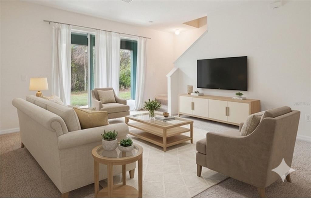 8986 Indigo Trail Loop Riverview, FL 33578 - Photo 14 of 48 a living room with furniture a flat screen tv and a window