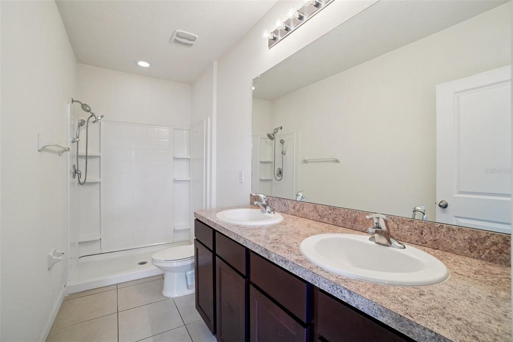 8986 Indigo Trail Loop Riverview, FL 33578 - Photo 39 of 48 a bathroom with a granite countertop sink and a mirror