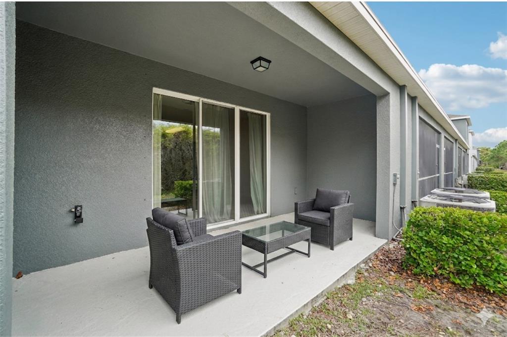 8986 Indigo Trail Loop Riverview, FL 33578 - Photo 40 of 48 a building outdoor space with patio furniture