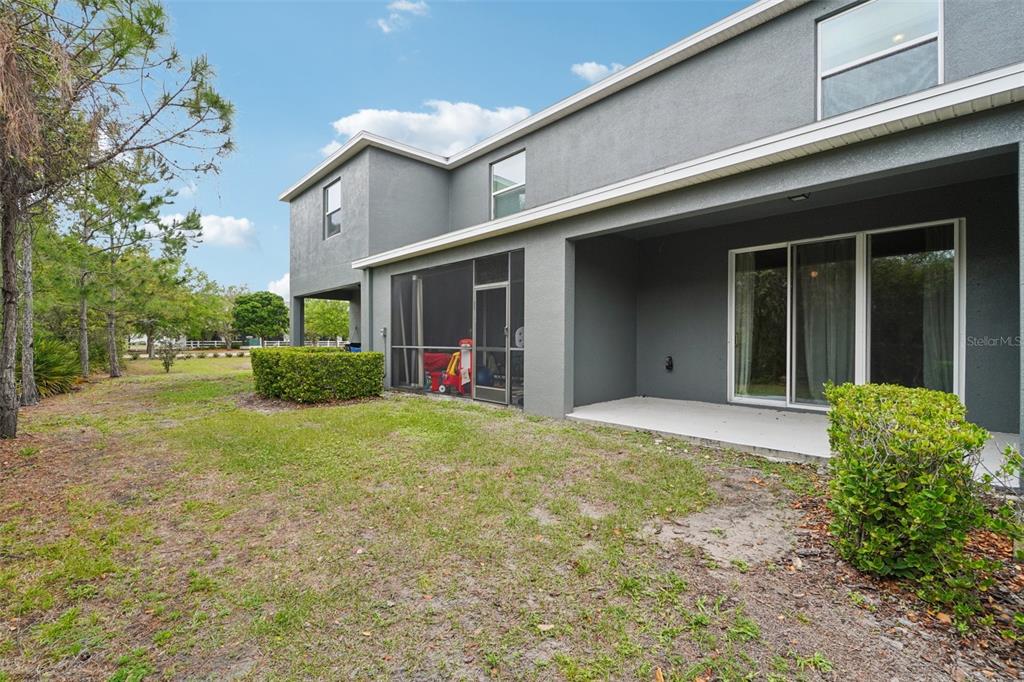 8986 Indigo Trail Loop Riverview, FL 33578 - Photo 44 of 48 a view of a house with backyard and porch