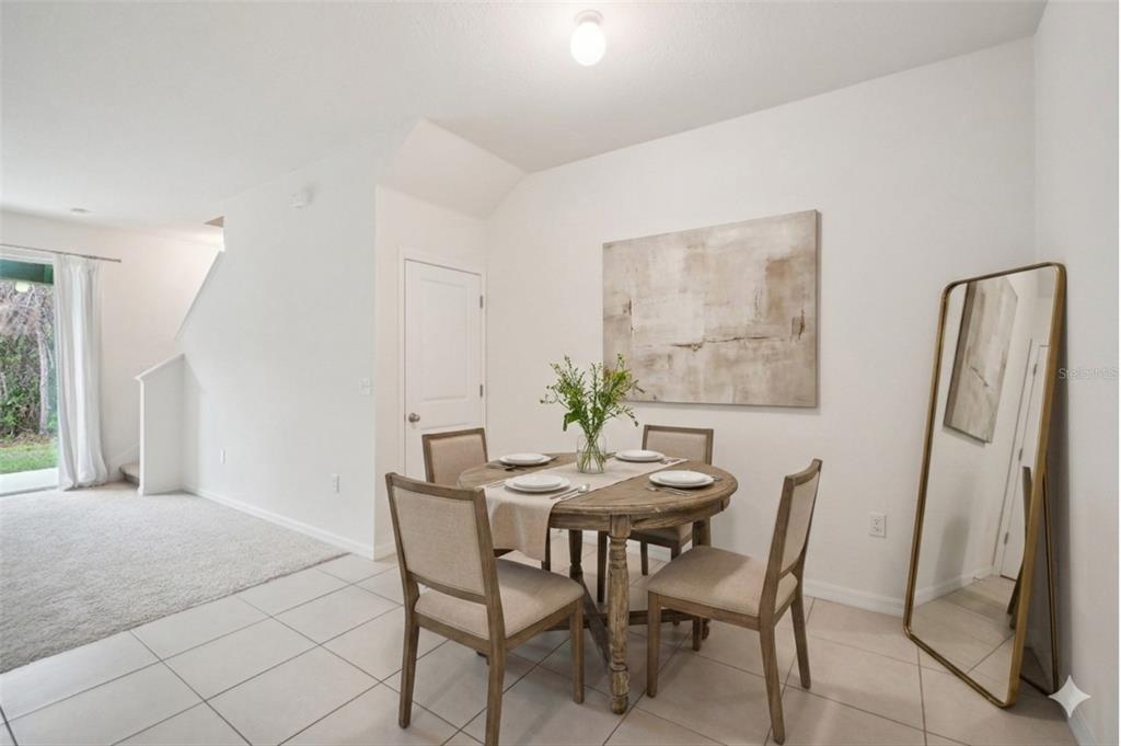 8986 Indigo Trail Loop Riverview, FL 33578 - Photo 6 of 48 a view of a dining room with furniture and a potted plant