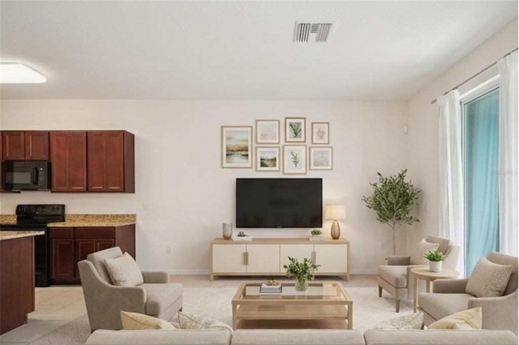 8986 Indigo Trail Loop Riverview, FL 33578 - Photo 9 of 48 a living room with furniture and a flat screen tv