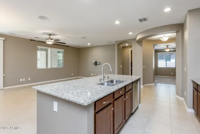 a kitchen with center island table and chairs