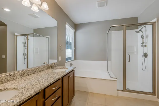 a bathroom with a granite countertop sink mirror and shower