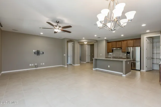 a view of a kitchen with a sink and stainless steel appliances