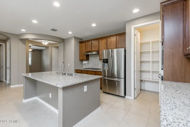 a kitchen with stainless steel appliances a refrigerator and a sink