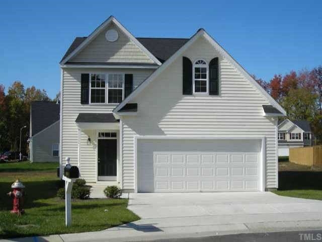 3208 Rendezvous Drive Raleigh, NC 27610 - Photo 1 of 2 a front view of a house with a yard and garage