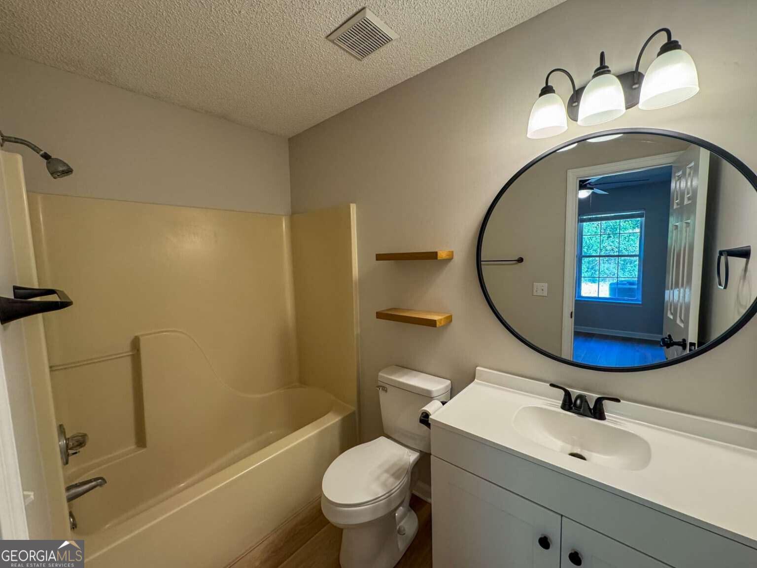 110 Talbot Court St. Marys, GA 31558 - Photo 6 of 16 a bathroom with a sink mirror bathtub and toilet