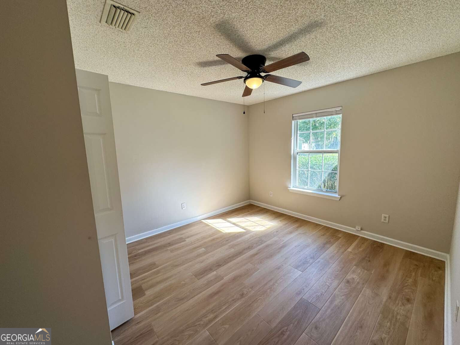 110 Talbot Court St. Marys, GA 31558 - Photo 7 of 16 an empty room with wooden floor and windows