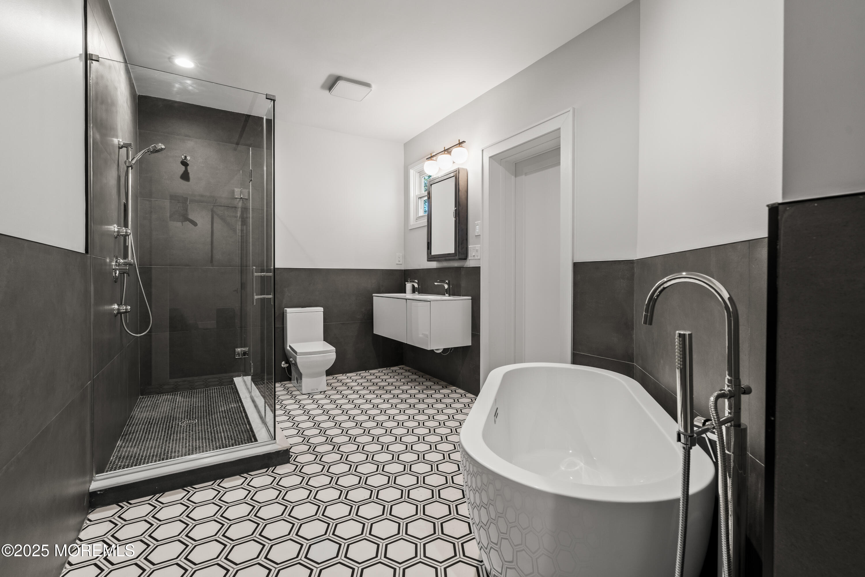 73 3rd Avenue Atlantic Highlands, NJ 07716 - Photo 41 of 57 a bathroom with a sink a toilet a mirror and shower