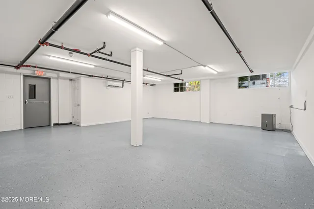 aerial view of a house with a yard and large trees