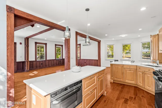a kitchen with a sink a stove a refrigerator and cabinets