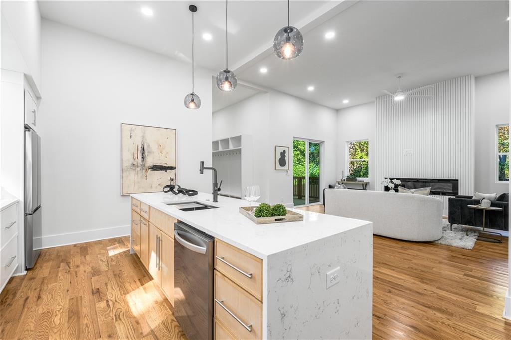 271 Haas Avenue Southeast Atlanta, GA 30316 - Photo 11 of 56 a large white kitchen with a large island oven a stove a sink a dining table and chairs