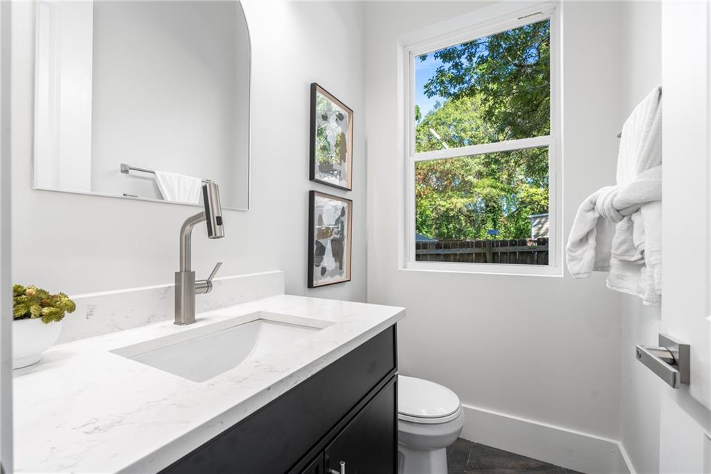 271 Haas Avenue Southeast Atlanta, GA 30316 - Photo 18 of 56 a bathroom with a granite countertop sink and a large mirror