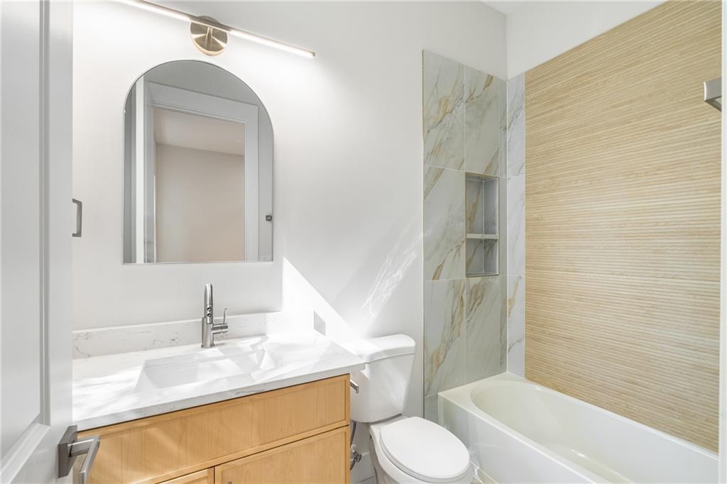 271 Haas Avenue Southeast Atlanta, GA 30316 - Photo 28 of 56 a bathroom with a granite countertop sink toilet and shower