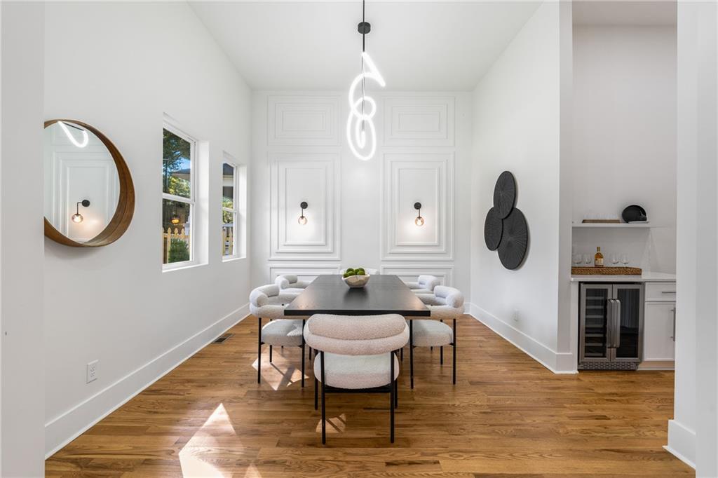 271 Haas Avenue Southeast Atlanta, GA 30316 - Photo 42 of 56 a dining room with wooden floor a chandelier a wooden table and chairs