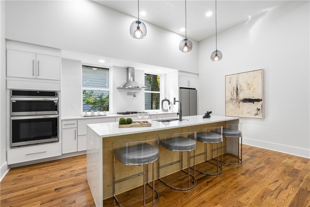 271 Haas Avenue Southeast Atlanta, GA 30316 - Photo 7 of 56 a kitchen with a stove a microwave a dining table and chairs